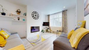 a living room with a couch and a tv at Redwood in Longton