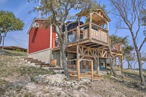 a tree house with stairs up to it at Kerrville Converted Barn Tiny Home with Kayaks! in Kerrville