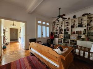 a woman standing in a living room with a couch at Via Arriba B&B in Buenos Aires