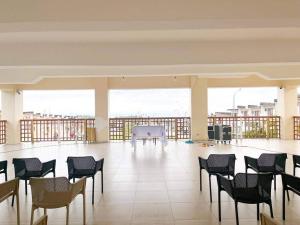 a large room with chairs and a table in it at Townhouse with game area and access to swimming pool in San Fernando