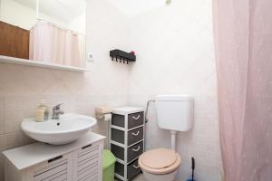 a small bathroom with a sink and a toilet at APARTMENT MAJER 2 in Medulin +46 photos