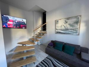 Apartments in Art Nouveau District في ريغا: غرفة معيشة مع أريكة ودرج