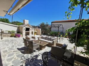 a patio with a couch and chairs and a table at Tisno Resort in Tisno