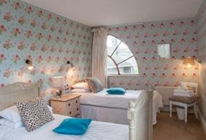 a bedroom with two beds and a window at Loughcrew House in Oldcastle