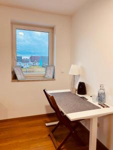 Habitación con escritorio y ventana con mesa. en Homestay Offers Private Bedroom and Bathroom near Speyer and Hockenheim, en Altlußheim