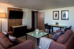 a living room with two couches and a table at The Cavendish London in London