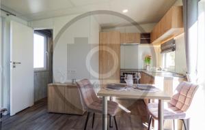 eine Küche und ein Esszimmer mit Tisch und Stühlen in der Unterkunft Tiny Haus 89 Am Brombachsee in Pleinfeld + 22 Fotos