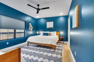 a blue bedroom with a bed and a window at Modern Rustic in Branson +66 photos