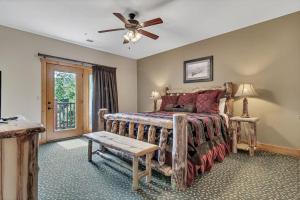 a bedroom with a bed and a ceiling fan at Riverhaven in Branson +39 photos
