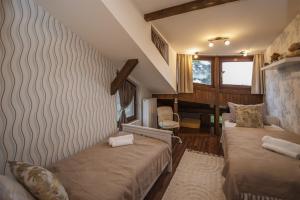a bedroom with two beds in a room at Hilltop Wellness Villa-big garden, sauna, hot tube in Pécs