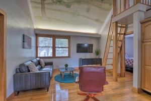 a living room with a couch and a staircase at Charming Gainesville Townhome Less Than 2 Mi to University in Gainesville