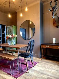 a dining room with a table and a mirror at Chic Townhouse near Tunnels Beaches Ilfracombe in Ilfracombe