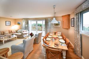 a dining room and living room with a table and chairs at Cedar Lodge in Portpatrick