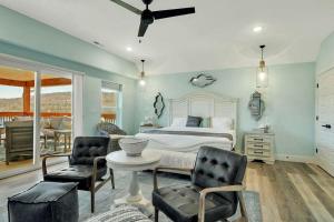 a bedroom with a bed and two chairs and a table at A Wave From It All in Hollister +100 photos