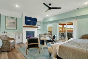 a bedroom with a bed and a table and chairs at A Wave From It All in Hollister