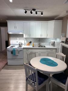 a kitchen with a table and a table and chairs at Newly Renovated Basement Suite! in Lethbridge