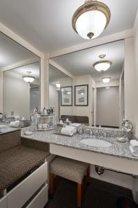 a bathroom with two sinks and a large mirror at O.Henry Hotel in Greensboro