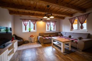 a living room with a couch and a table at Chata pod kopcom in Žarnovica