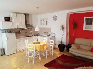 a kitchen and living room with a table with a candle on it at Apartment Luca in Prvić Luka