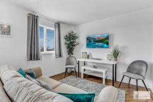 a living room with a couch and a desk at Silver Stag Properties, Spacious 3 Story House in Whitwick