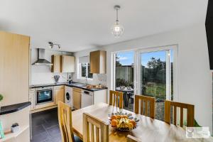 a kitchen and dining room with a table and chairs at Silver Stag Properties, Spacious 3 Story House in Whitwick