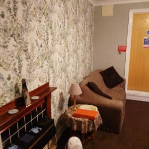 a living room with a couch and a table at Puffin Holiday Apartments in Bridlington