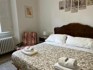 a bedroom with a bed with towels on it at Residenza La Libertà in Florence