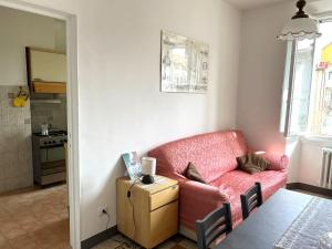 a living room with a red couch and a table at Residenza La Libertà in Florence +2 photos
