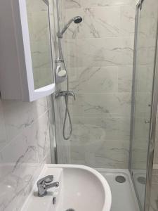 a bathroom with a shower and a sink and a mirror at 007- S1premium location studio apartment central London in London