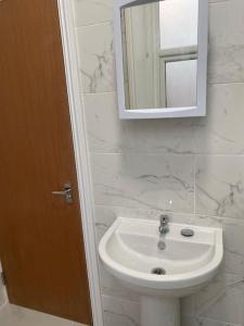 a bathroom with a white sink and a mirror at 007- S1premium location studio apartment central London in London
