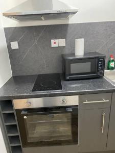 a kitchen with a microwave and a stove at 007- S1premium location studio apartment central London in London