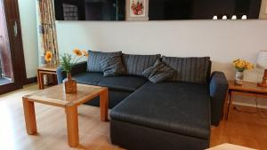 a living room with a couch and a table at BFE Schwarzwaldidylle in Baiersbronn