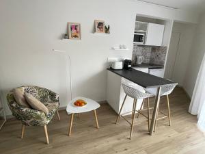 a small kitchen with a table and chairs in a room at Aix Homes "Les Allées Provençales" in Aix-en-Provence