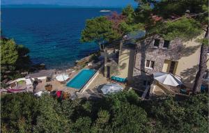 an aerial view of a house and a swimming pool at Nice Home In Prigradica With Jacuzzi, Wifi And Outdoor Swimming Pool in Prigradica
