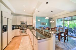 a kitchen with a large island and a dining room at Kona Coast Condo with Lanai and Outdoor Kitchen! in Waikoloa
