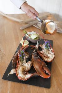 a plate of food with lobsters on a table at Hôtel Restaurant & Spa Plaisir in Le Bois-Plage-en-Ré