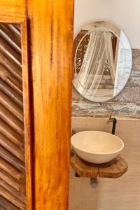 a bathroom with a sink and a mirror at Posada Gallinas in Palomino