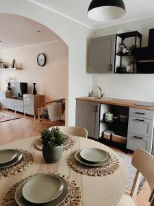 a kitchen and living room with a table and chairs at Rauna Apartment NR 8 in Rauna