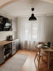 a kitchen with a table and a dining room at Rauna Apartment NR 8 in Rauna