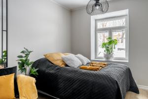 um quarto com uma cama com cobertores e almofadas em Fabia em Turku