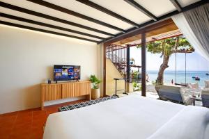 a bedroom with a bed and a view of the ocean at Lücke Boutique Hotel - Adults only in Ko Tao