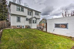 a white house with a yard next to a building at Central Eugene House with Updated Interior and Yard! in Eugene