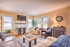 a living room with a couch and a fireplace at Central Eugene House with Updated Interior and Yard! in Eugene