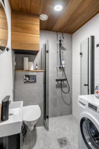 a bathroom with a shower and a toilet and a sink at Fabia in Turku