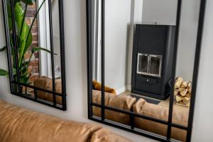 a living room with a couch and two mirrors at Fabia in Turku