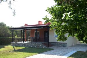 a house with a gazebo in the yard at Potamos Studios by GERANI in Órmos