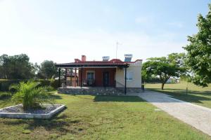 a small white house with a red roof at Potamos Studios by GERANI in Órmos