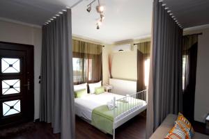 a bedroom with a white bed and a window at Potamos Studios by GERANI in Órmos