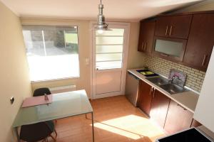 a small kitchen with a sink and a window at Potamos Studios by GERANI in Órmos