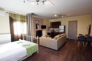 a bedroom with a bed and a living room at Potamos Studios by GERANI in Órmos